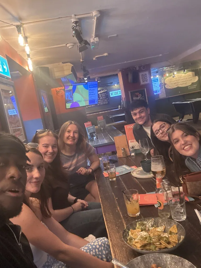 A smiling quiz team gathered around their pub table